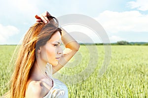 Woman at wheat field on sunny day