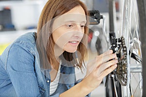 Woman with wheel in bikestore