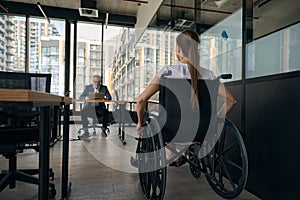 Woman in wheelchair applying for job in office