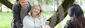 Woman in a wheelchair chats with friends in park