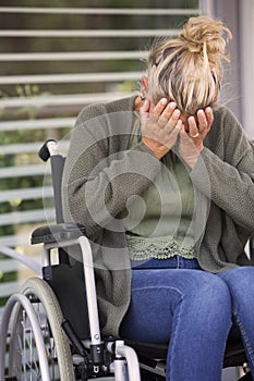 Woman in a wheelchair is crying