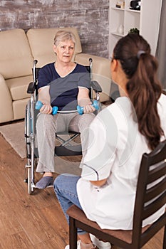 Woman in wheelchair discussing with nurse
