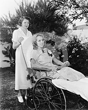 Woman in wheelchair with nurse