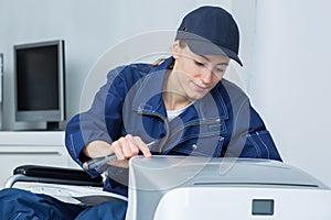 Woman in wheelchair repairing appliance