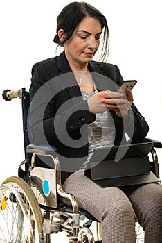 Woman in wheelchair sending message by phone