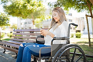 Woman in wheelchair with a smartphone