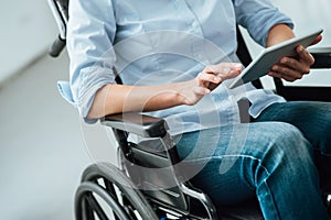 Woman in wheelchair using a tablet