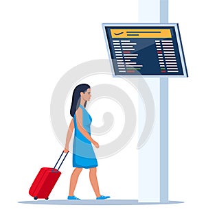 Woman with wheeled suitcase hurrying to flight at airport. Passenger in airport waiting room or departure lounge with information