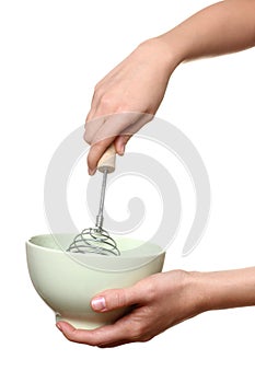 Woman whips whisk something in a bowl photo