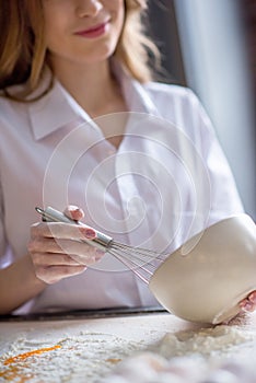 Woman whisking eggs in bowl