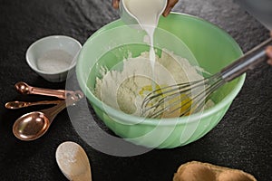 Woman whisking flour in bowl