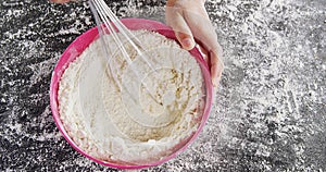 Woman whisking flour in bowl 4k