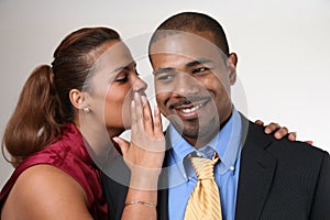 Woman whispering in husband's ear