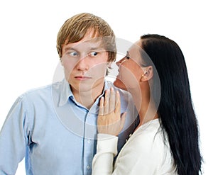 Woman whispering to a man.