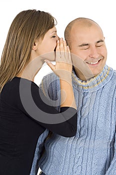 Woman whispers on an ear to the young man