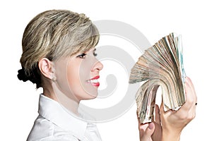 Woman in white blouse holding a wad of money