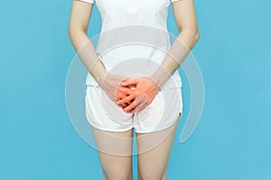 Woman in white clothes put her hands on the genitalia area,hand on spot of ache and red mark, Penis pain or Itching urinary Health