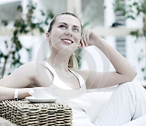 Woman in white with coffee