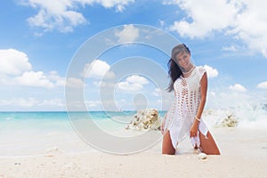 Woman in a white dress on beach