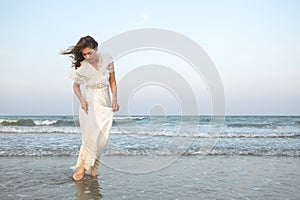 Woman in white dress on beach