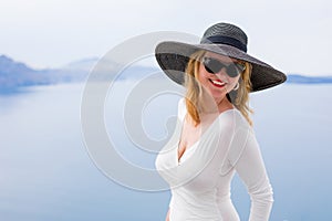 Woman in white dress and black hat