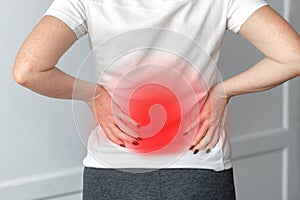 A woman in white dress feeling pain on his back. Office syndrome. Back pain from work. Herniated nucleus pulposus. spine