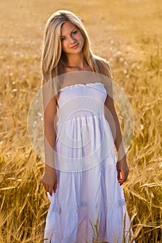 Woman in white dress on field