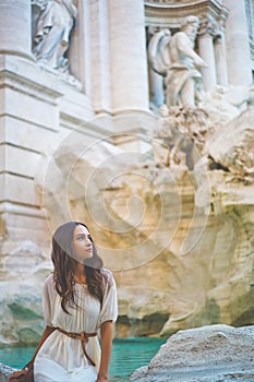 Woman in white dress in front of Trevi Fountain in Rome