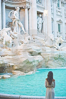 Woman in white dress in front of Trevi Fountain in Rome