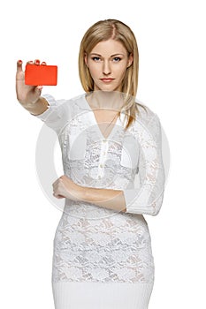 Woman in white dress holding empty credit card