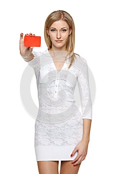 Woman in white dress holding empty credit card