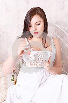 Woman in white dress open box