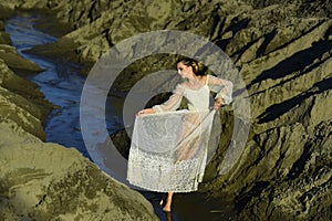 Woman in white dress pose in water, fashion