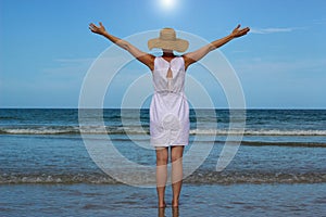 Woman In White Dress Raising Arms Looking At Ocean