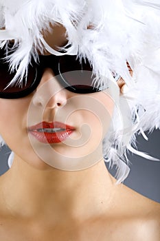 Woman with white feather wig and sunglasses