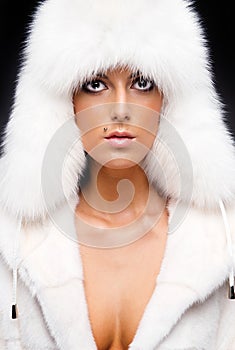 Woman in white fur coat and cap