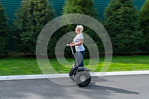 Woman with white hair riding personal transporter