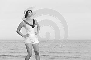 Woman in a white hat on background of the sea