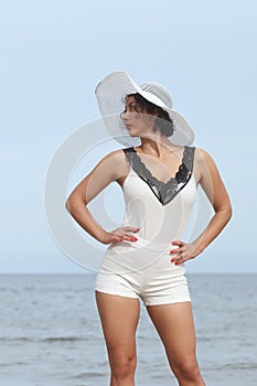 Woman in a white hat on background of the sea