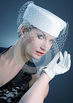 Woman in white hat with net veil