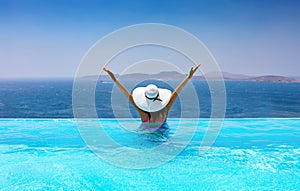 Woman with white hat in the pool