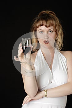 Woman in white having a glass of wine