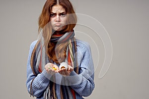 woman with white jar in hand pills vitamins health problems runny nose