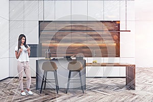 Woman in white kitchen with bar