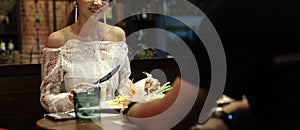 Woman white lace dress have dinner in restaurant photo
