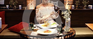 Woman white lace dress have dinner in restaurant photo