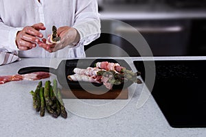 Woman in White Linen Shirt Cooking Fresh Asparagus.