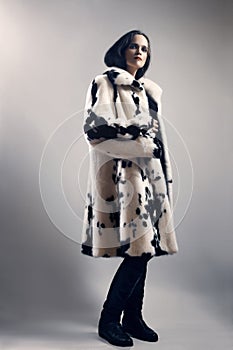 Woman in white mink spotty fur coat