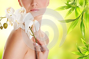 Woman with white orchid flower