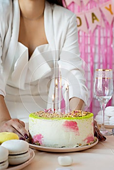 Woman in white party clothes preparing birthday table